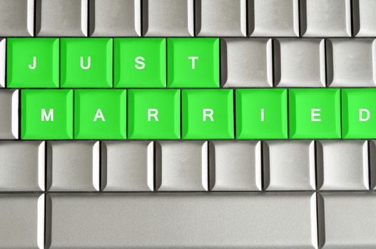 Just Married  spelled on a silver metallic keyboard