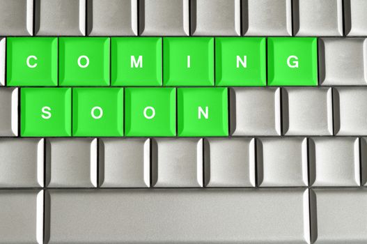 Coming Soon spelled on a silver metallic keyboard