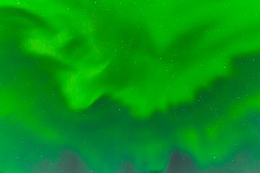 Background texture pattern abstract of green Aurora borealis or northern lights bands on night sky full of stars