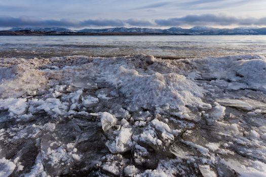 Shore ice piles up during freezing of Lage Laberge, Yukon Territory, Canada, winter landscape