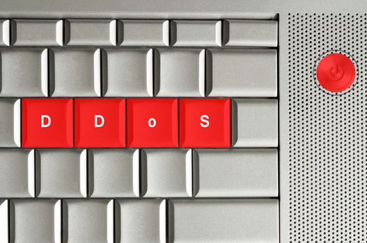 distributed denial of service in red on a metallic keyboard