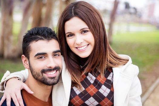 Young romantic couple on a bench in park