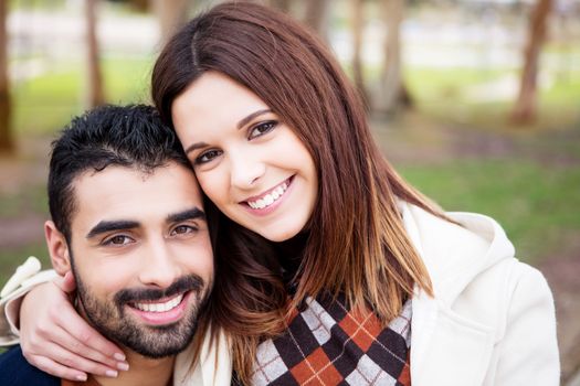 Young romantic couple on a bench in park