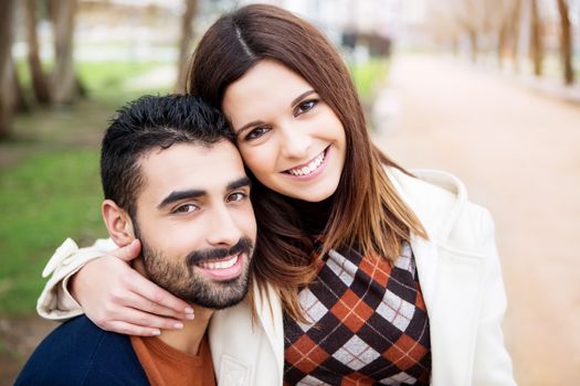 Young romantic couple on a bench in park