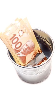 Hundred Canadian dollar bills in an aluminium  pot