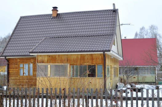 The wooden house in a housing estate