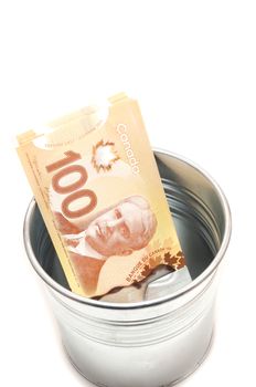 Hundred Canadian dollar bills in an aluminium  pot
