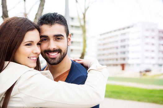 Young romantic couple on a bench in park