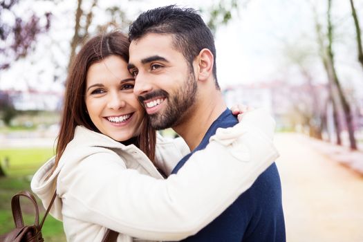 Young romantic couple on a bench in park