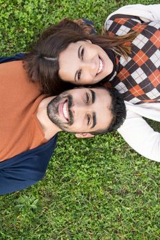 Happy couple relaxing on the grass park