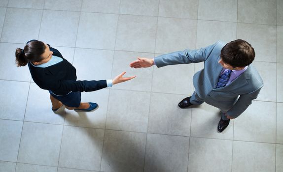 image of a businessmen stretching out their hands towards each other, the future handshake