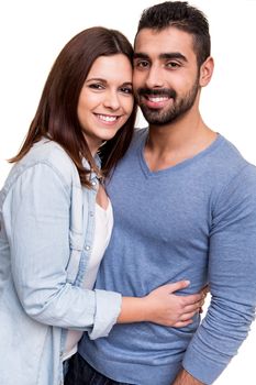 Young love couple hugging over white background