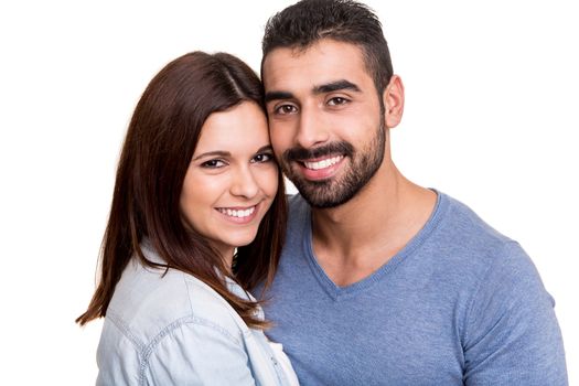 Young love couple hugging over white background