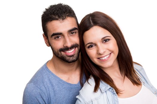 Young love couple hugging over white background