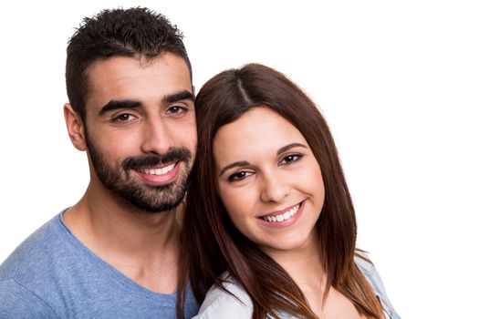 Young love couple hugging over white background