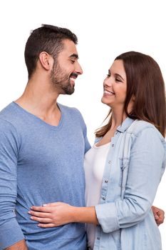 Young love couple hugging over white background