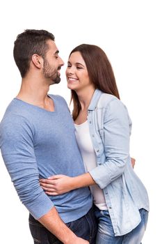 Young love couple hugging over white background