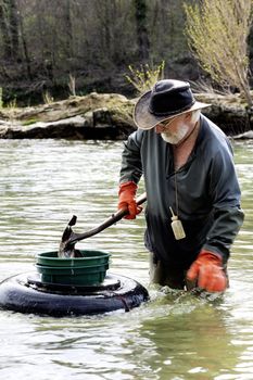 Gold digger in France in the region of Cevennes and the department of Gard in the middle of the river called Le Gardon.