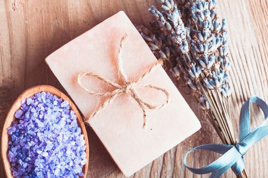 Lavender treatment soap and sea salt on wooden table