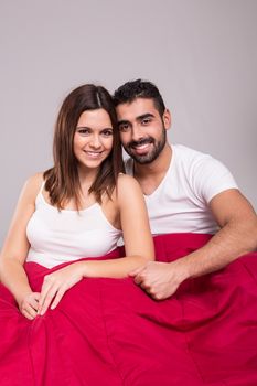 Young love couple relaxing together in bed