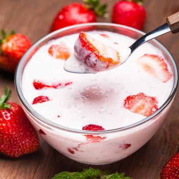 Strawberry yoghurt in a bowl on the  table