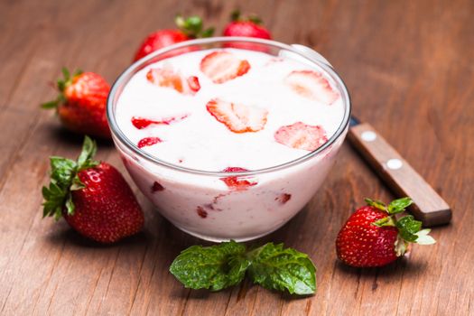 Strawberry yoghurt in a bowl on the  table