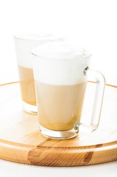 Coffee latte in glass mugs on the board