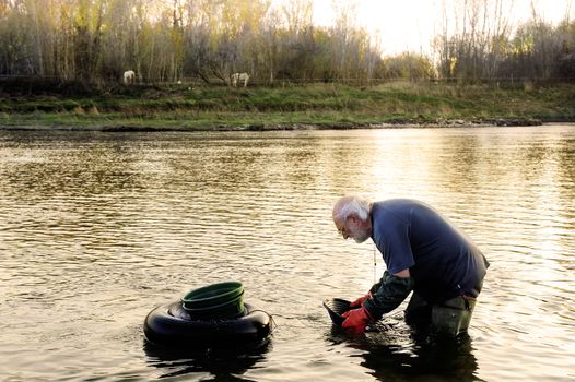 Gold digger in France in the region of Cevennes and the department of Gard in the middle of the river called Le Gardon.