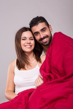 Young love couple relaxing together in bed 