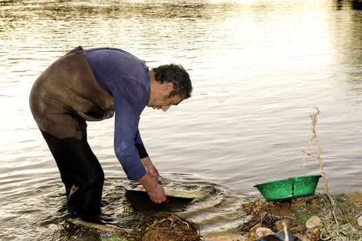 Gold digger in France in the region of Cevennes and the department of Gard in the middle of the river called Le Gardon.