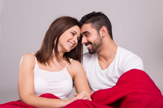 Young love couple relaxing together in bed 