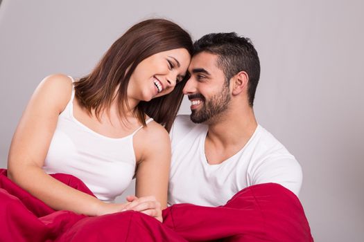 Young love couple relaxing together in bed 