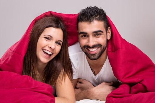 Young love couple relaxing together in bed 