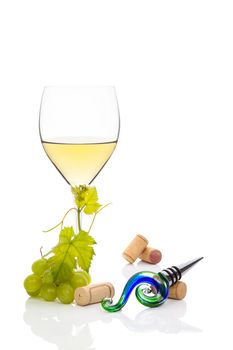 White wine with green grapes, wine corks and vine leaves isolated on white. Luxurious culinary wine drinking background.