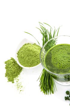 Green natural superfood. Detox. Healthy living. Wheatgrass, chlorella spirulina. Ground powder, pills, green juice and blades.