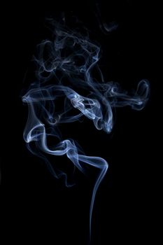 Blue smoke isolated on black background. Abstract background.