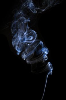 Blue smoke swirl isolated on black. Abstract background.