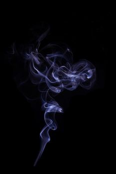 Beautiful purple smoke isolated on black background. Abstract artistic backdrop.