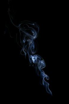 Blue smoke isolated on black background. Abstract background.