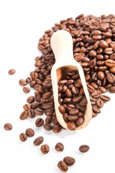 Coffee beans with wooden scoop isolated on white background. Traditional coffee background.