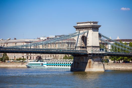 Cruise ships on Danube river with Chain Bridge in front  and Parliament Building in the background, Budapest.