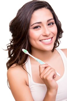 Smiling young woman with healthy teeth holding a tooth brush