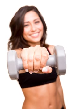 Beautiful fitness woman lifting weights