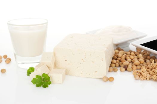 Soy milk, tofu, soybeans, granules and soy sauce isolated on white background. Culinary vegetarian and vegan eating background. 