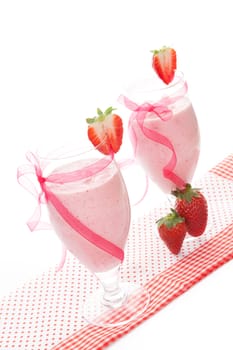 Delicious strawberry milk shake with fresh strawberries isolated on white background, vintage style. Refreshing healthy summer drink.