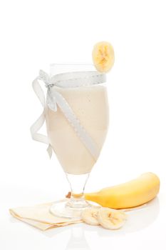 Delicious banana smoothie with banana isolated on white background. Fresh summer drink.