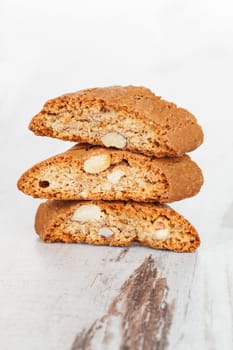 Cantuccini stack on white wooden textured background. Traditional italian culinary sweet dessert.