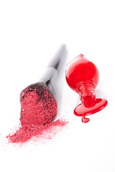 Luxurious cosmetics background in red and white. Red nail polish and makeup brush with pink powder isolated on white background. Feminine beauty concept.