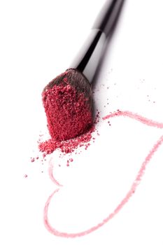 Glamour makeup background. Brush with purple makeup powder and heart drawn with lipstick isolated on white background. Beauty and love background.