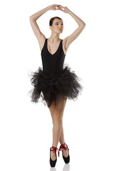 classic dancer with black dress and shoes on white background dancing on pointe